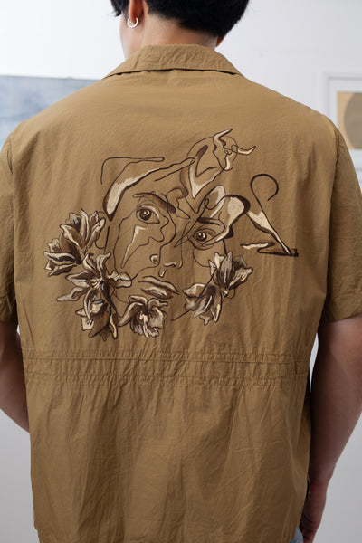 Detail back view of tan bowling men's shirt with hand painted abstract portrait by nowhere studio