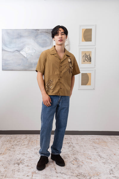 Full front view of tan bowling men's shirt with hand painted motifs by nowhere studio