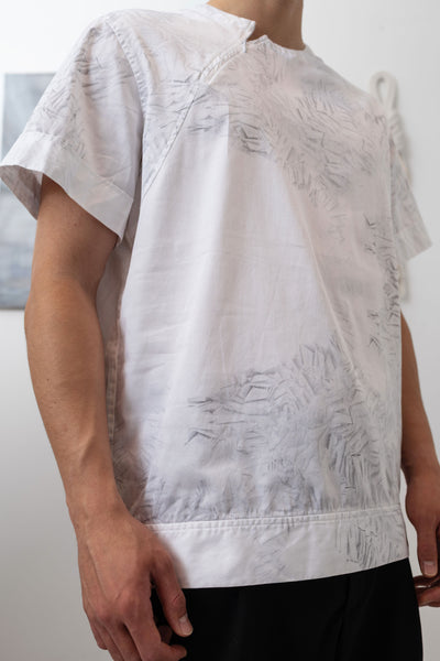 Detail of white printed menswear shirt with trompe l'oeil print and reinforced hemband by nowhere studio