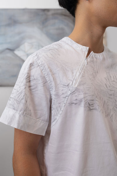 Front detail of white printed menswear shirt with trompe l'oeil print and zipper closure by nowhere studio