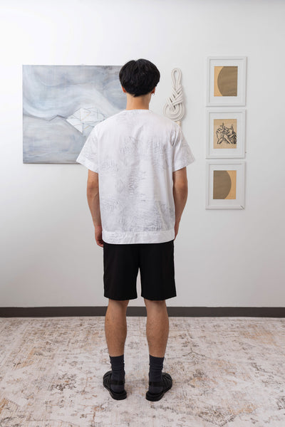 Full back view of white printed short sleeve menswear shirt with  hemband by nowhere studio