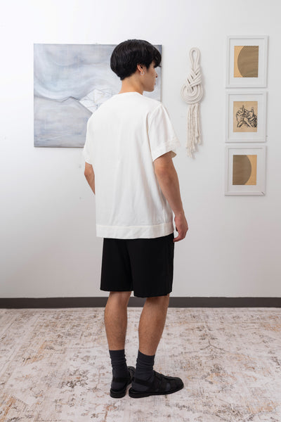 Full back view of white menswear shirt with hem band and reinforced seams by nowhere studio