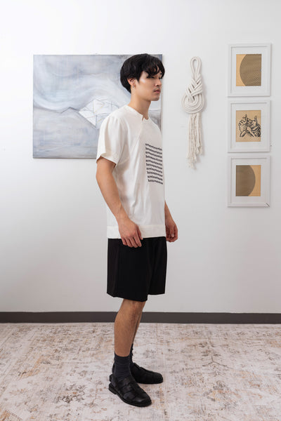 Full side view of white menswear shirt with embroidered graphic,  invisible zipper and reinforced seams by nowhere studio