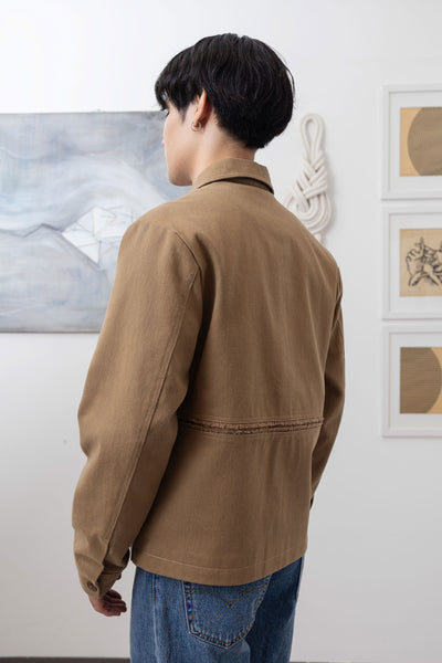 Earth workwear jacket close-up back left, artisanal construction and reinforced seam detail by nowhere studio