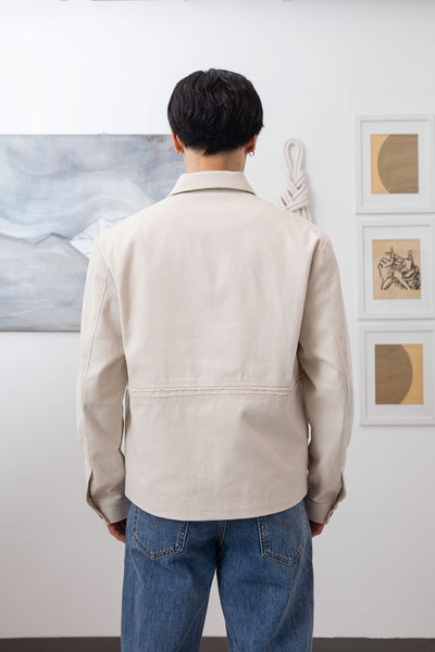 Ivory workwear jacket close-up back, artisanal construction and reinforced seam detail by nowhere studio