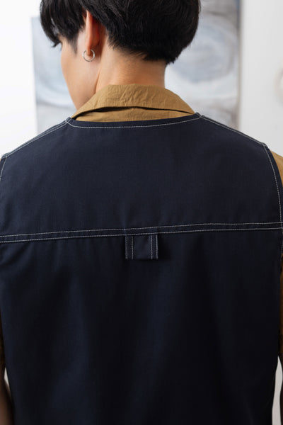 Back detail of fisherman's vest in Admiral mid-weight twill with double-needle topstitching and D-ring hardware by nowhere studio