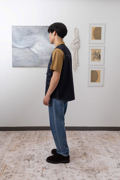 Full left side view of fisherman's vest in Admiral mid-weight twill with relaxed silhouette and reinforced seams by nowhere studio