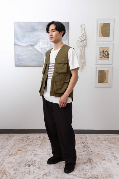 Full left side view of fisherman's vest in Army mid-weight twill with relaxed silhouette and reinforced seams by nowhere studio