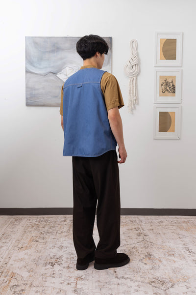 Full back right view of fisherman's vest in Denim mid-weight twill with reinforced seams and utilitarian construction by nowhere studio