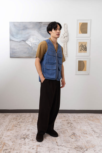 Full profile view of fisherman's vest in Denim mid-weight twill with 3D cargo pockets and D-rings by nowhere studio