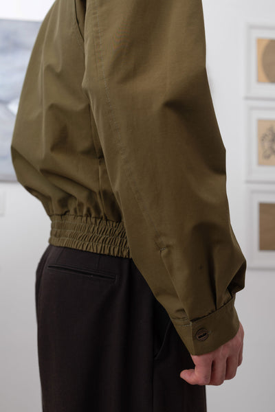 Army Harrington jacket side detail, buttoned cuff closure on water-resistant nylon by nowhere studio