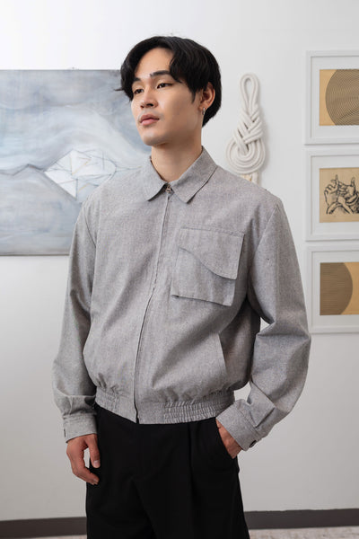 Close-up left of Granite Harrington jacket with cargo pocket and soft blouson fit by nowhere studio