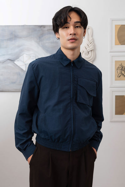 Navy Harrington jacket close-up front, cargo pocket with organic curve flap and zipper closure by nowhere studio