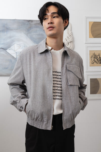  Front detail view of Granite Harrington jacket with utility details and metal zipper closure by nowhere studio