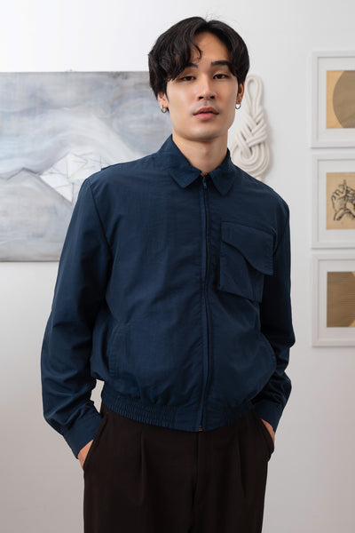 Navy Harrington jacket close-up front, cargo pocket with organic curve flap and zipper closure by nowhere studio
