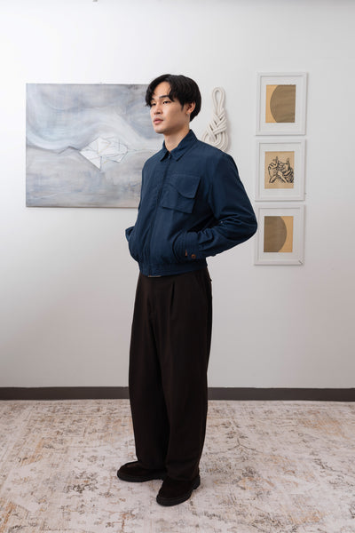 Navy Harrington jacket full left side view, elasticized waistband and utilitarian pockets by nowhere studio