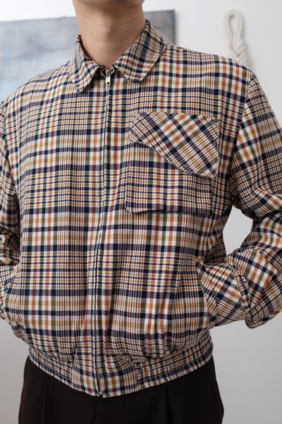 Yarn dye plaid Harrington jacket front detail, curved cargo pocket flap and metal zip by nowhere studio