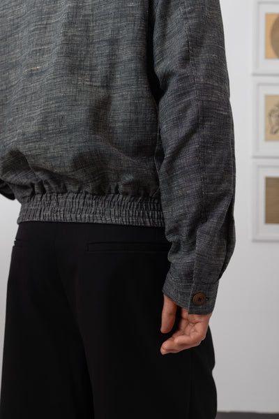 Yarn dye navy Harrington jacket sleeve detail, button cuff closure on textured yarn dye weave by nowhere studio