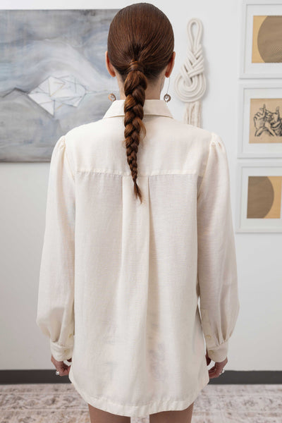 Close-up back detail of sculptural blouse in ivory — sculptural volume with quiet movement and woven construction, nowhere studio
