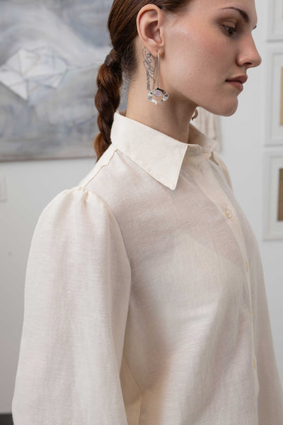 Front right detail of sculptural blouse in ivory — structured neckline with architectural finish, nowhere studio