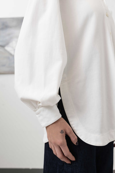 Sleeve detail of sculptural blouse in white — exaggerated sculptural volume in woven fabric, nowhere studio