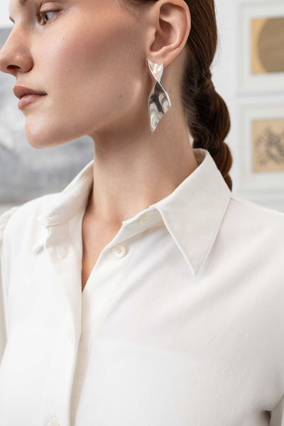 Collar detail of sculptural blouse in white — structured neckline with architectural finish, nowhere studio