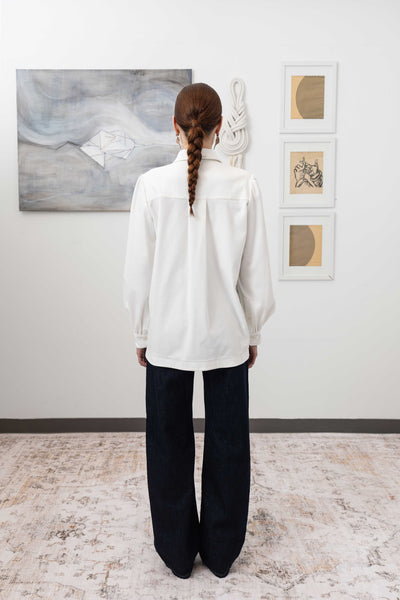 Sculptural blouse in white, full back view — sculptural volume with quiet movement and structured hem, nowhere studio