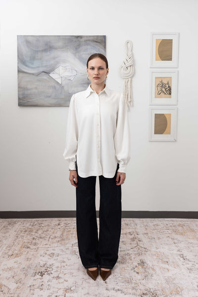 Sculptural blouse in white, full front view — voluminous form with sculptural drape in woven fabric, nowhere studio