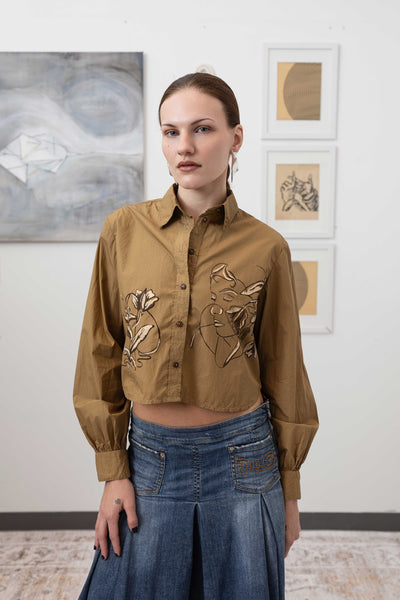 Close-up front view of hand painted artisanal blouse in tan — brushwork detail on breathable woven fabric, nowhere studio
