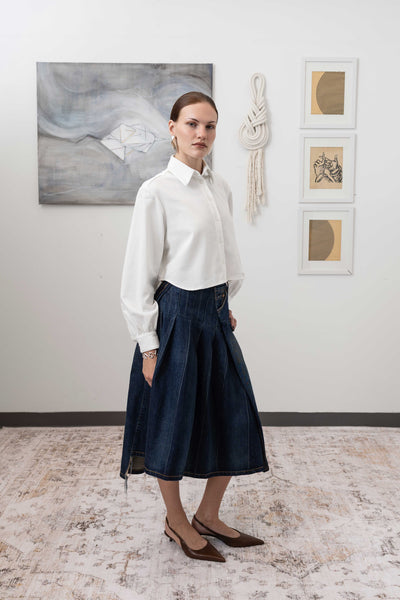 Artisanal blouse in white, profile view — fluid silhouette with softly gathered sleeves, nowhere studio