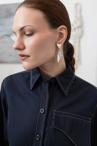 Front detail of Admiral utilitarian shirt — three-dimensional cargo pocket with graphic topstitching accent, nowhere studio