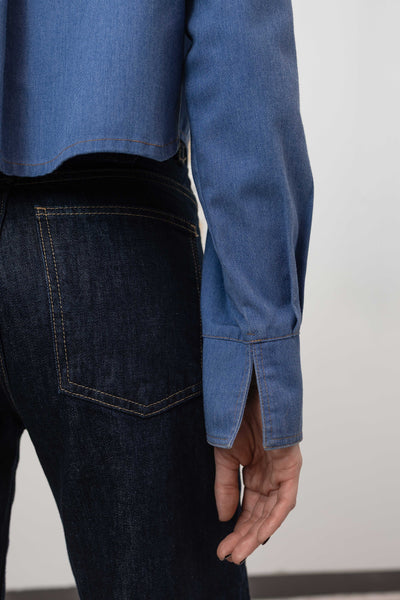 Sleeve detail view of denim utilitarian shirt — contrast double-needle topstitching on eco twill, nowhere studio