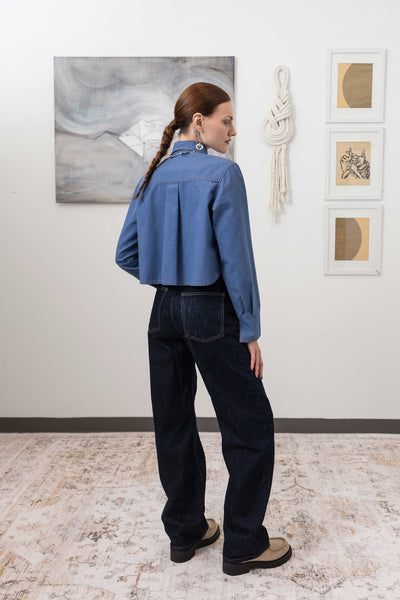 Utilitarian shirt in denim, back right view with double-needle contrast topstitching, nowhere studio