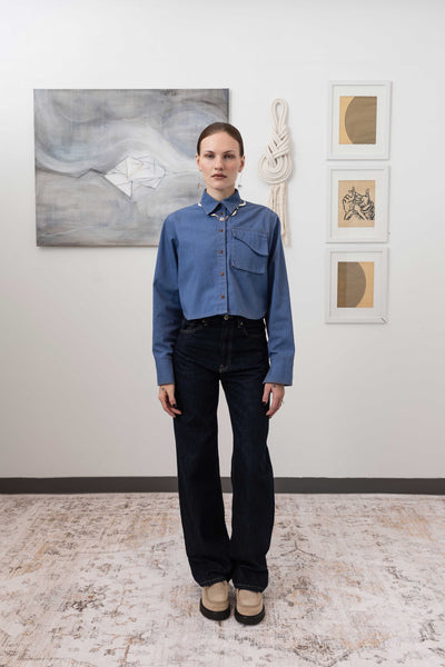 Utilitarian shirt in denim, full front view with shrunken silhouette with cargo pocket, nowhere studio