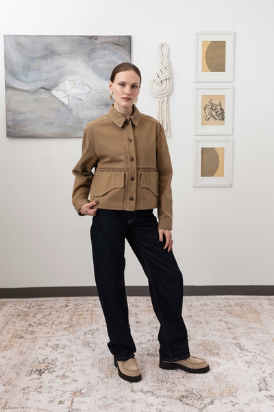 Workwear jacket in earth, full front view closed — relaxed shrunken silhouette with Corozo buttons and selvedge fringe panel, nowhere studio