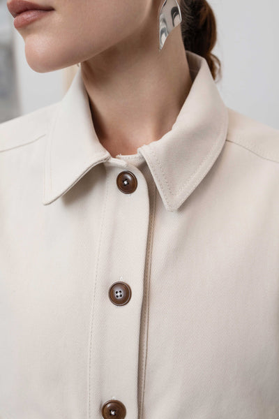 Collar detail of workwear jacket in ivory — structured neckline with Corozo button and reinforced seam finish, nowhere studio