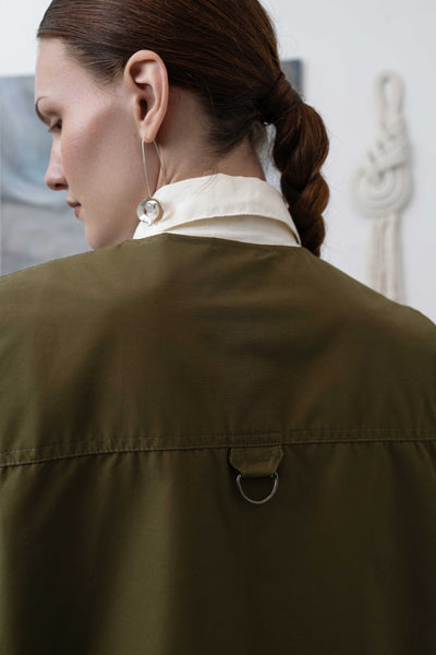 Back detail of fisherman's vest in Army mid-weight twill — double-needle topstitching and hardware finish, nowhere studio