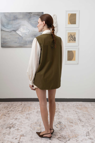 Full back view of fisherman's vest in Army mid-weight twill with double-needle topstitching and structured hem by nowhere studio