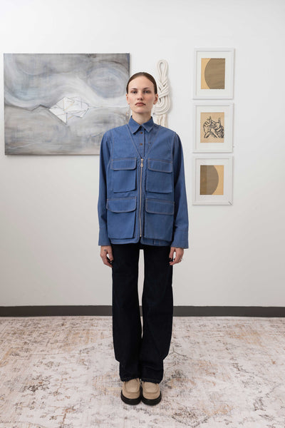 Full front view of fisherman's vest in Denim mid-weight twill with 3D cargo pockets and zipper closure by nowhere studio