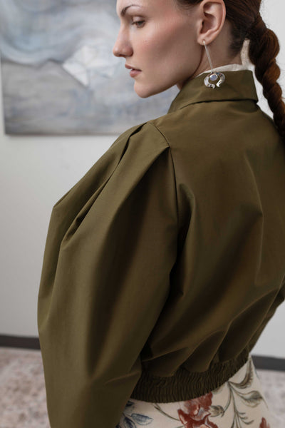 Back detail of sculptural blouson jacket in army — sculptural pleated sleeves in Italian mill deadstock nylon, nowhere studio