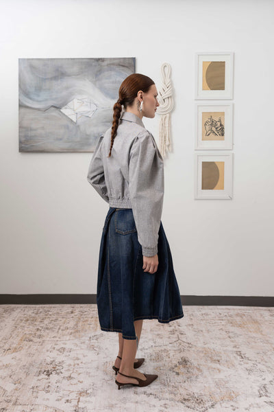 Sculptural blouson jacket in granite, full back right view — modernist sculptural form with elasticized hem and organic hand, nowhere studio