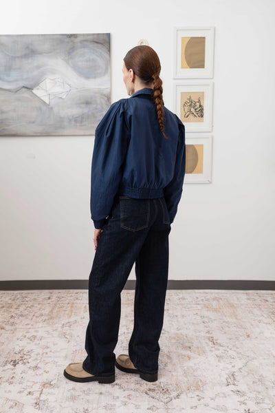 Sculptural blouson jacket in navy, full back left view — modernist sculptural form with elasticized hem in lightweight nylon, nowhere studio