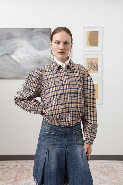 Close-up front view of sculptural blouson jacket in yarn-dye plaid — metal zip and welt pocket detail in European yarn-dyed twill, nowhere studio