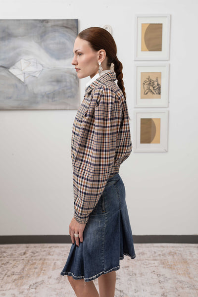 Close-up left side detail of sculptural blouson jacket in yarn-dye plaid — pleated sleeve construction in yarn-dyed twill, nowhere studio