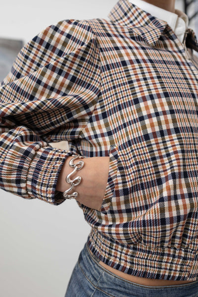 Front detail of sculptural blouson jacket in yarn-dye plaid — metal zip closure and welt pocket in European yarn-dyed twill, nowhere studio