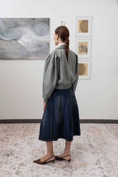 Sculptural blouson jacket in silver, full back left view — modernist sculptural form with elasticized hem in lightweight nylon, nowhere studio