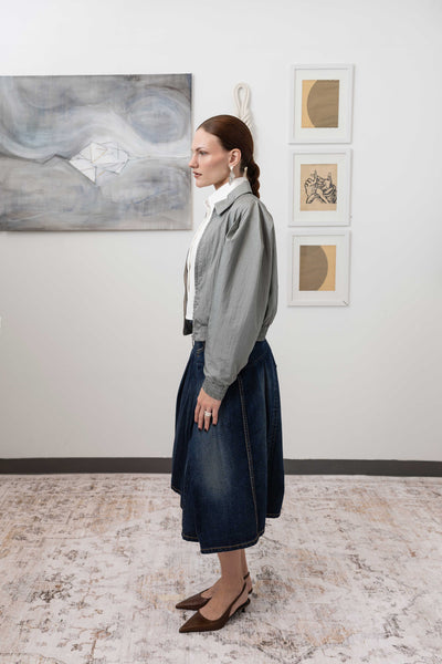 Sculptural blouson jacket in silver, left side view — elasticized hem and gathered waist in water-resistant nylon, nowhere studio