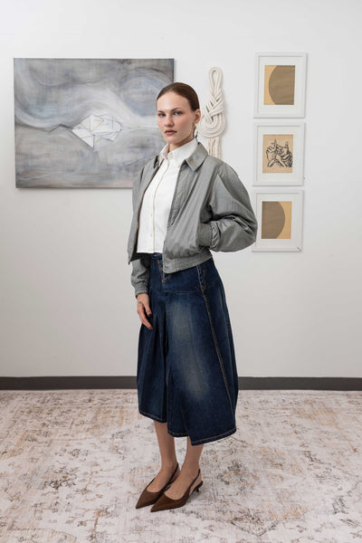Sculptural blouson jacket in silver, profile view — rounded silhouette with softened structure and crinkled nylon surface, nowhere studio